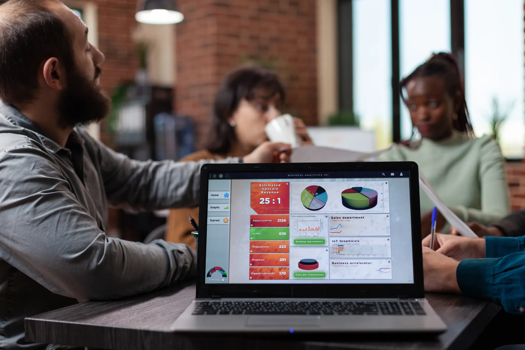 A team reviewing company charts on a laptop in an office